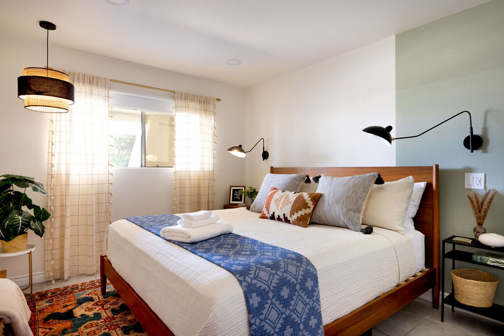 Bedroom with wall sconce and mid-century details